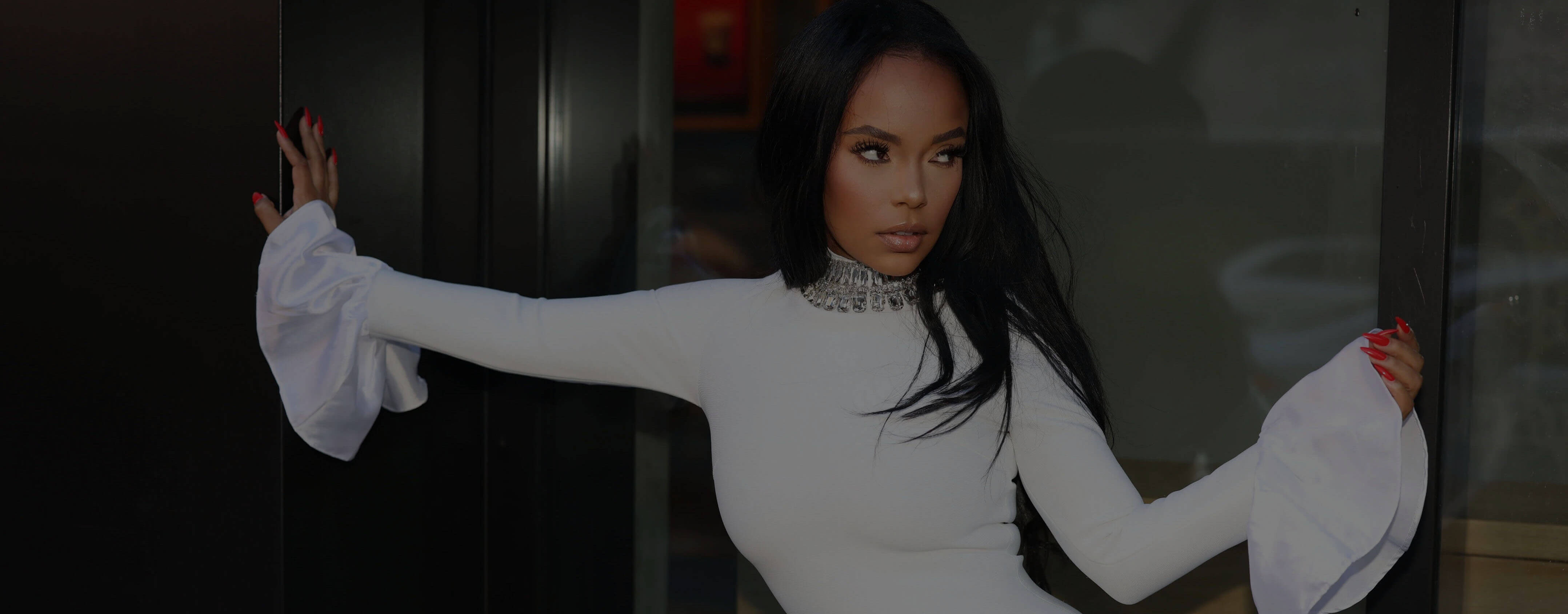 Nichole Lynel posed in a diamond-collar white bandage dress.